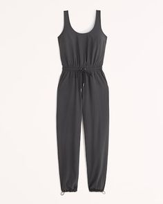 Easy-fitting jumpsuit in our comfy, active Traveler fabric, featuring adjustable wide straps, scoop neckline, elastic waist detail with exterior drawcords and metal aglets and pockets. Imported. Neutral Spring Outfit, Black Sleeveless Jumpsuit, Transition Outfits, Cute Spring Outfits, Weekly Outfits, Neutral Outfit, Fall Fashion Trends, Sleeveless Jumpsuits, Rompers Women