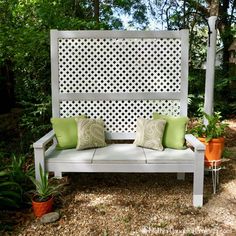 a white bench sitting in the middle of a garden