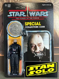 a star wars action figure with a coin in its package and the box is open