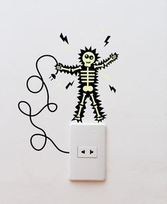 a wall mounted light switch with a skeleton sticker on it's face and arms