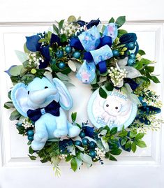 a blue wreath with an elephant and baby's breath on it