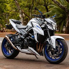 a white and blue motorcycle parked on the street