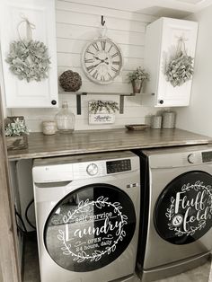 a washer and dryer sitting next to each other in front of a clock