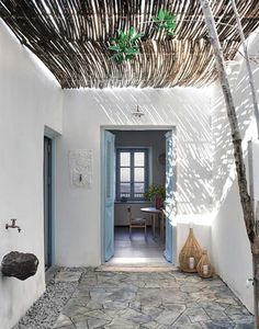 an entry way with stone flooring and white walls