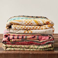 a stack of cloths sitting on top of a wooden table