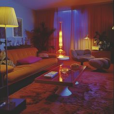 a living room filled with lots of furniture and a lamp on top of a table