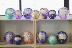 several colorfully painted faces are on shelves