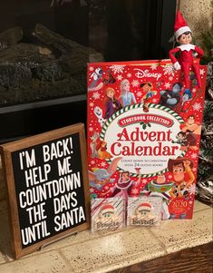 an elf's christmas calendar sits on a mantle next to a sign that says i'm back help me count down the days until santa