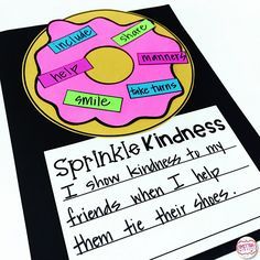 a pink donut sitting on top of a piece of paper with words written in it