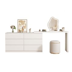 a white dresser sitting next to a mirror and stool