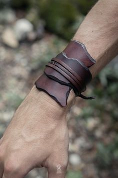 Simple yet elegant, this leather bracelet is made with scraps of natural vegetable tanned leather. Dyed and sewn by hand, this cuff is unisex and adjustable to any size. It is the perfect accessory to enhance your costume or outfit. Material : genuine leather Lenght : 26 to 28cm Width : from 4 to 8cm All items are made to order. Manufacturing and shipping from Switzerland currently takes up to 4-5 weeks. If you are not sure about sizing or measurements, if you have any question or should you nee Adjustable Leather Cuff Bracelet, Adjustable Unique Leather Bracelet, Adjustable Hand Wrapped Leather Bracelet, Adjustable Rugged Leather Bracelet, Rugged Leather Bracelets, Artisan Leather Bracelets For Festivals, Festival Leather Bracelets With Hand Wrapped Details, Festival Leather Bracelets Hand Wrapped, Unique Brown Leather Bracelets