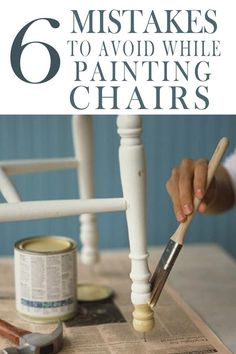 a person painting the legs of a white chair with paint and brushes on top of it