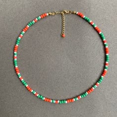 Orange Green White Beaded Necklace -2mm Round Seed Beads - Gold Plated Closure - 14'' with a 2'' extended chain. (Necklace length can be customized.) 🎁 Your product will come with great care with our free gift boxes. ► INFORMATION :  💎 Please note that slight color variations may occur due to the settings of your monitor. 📨 Please feel free to message us with any questions or concerns. We are more than happy to assist you in the best way possible!   ►  PROCESSING AND SHIPPING: ✅   Processing Summer Orange Necklaces With Colorful Beads, Summer Colorful Beaded Orange Necklace, Adjustable Orange Necklaces With Colorful Beads, Orange Seed Bead Necklace, Green Colorful Beads Choker For Beach, Jewelry Kids, White Beaded Necklace, Girl Necklace, Orange Necklace