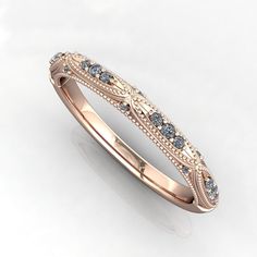 a rose gold wedding band with blue and white diamonds