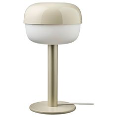 a white table lamp sitting on top of a metal base