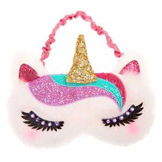 a pink and blue unicorn mask with a gold horn