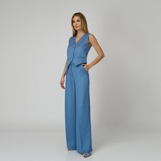 Introducing our Skye Silk Crepe Pants, a statement of luxurious comfort and timeless style. Tailored from  blue silk crepe with a wide-leg cut, they feature expertly placed darts that contour the waist and flatter the silhouette. The pressed crease detail offers a touch of refinement, elevating the overall look with understated polish. A concealed zipper and hook fastening in the front ensures a seamless finish, while the inclusion of pockets adds a practical yet chic element to the ensemble.  M Tailored Blue Wide Leg Pants For Formal Occasions, Tailored Wide Leg Blue Pants For Formal Occasions, Modern Blue Wide-leg Pants, Blue Wide Leg Pants For Evening, Elegant Blue Wide Leg Pants, Elegant Fitted Blue Wide Leg Pants, Elegant Blue Wide Leg Pants For Work, Elegant Wide Leg Silk Pantsuit, Chic Blue Silk Pants