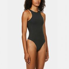 A classic. everyday style. this High Neck Bodysuit provides coverage and supportive stretch that hugs your body. This bodysuit is the perfect base layer and features a high cut leg opening and thong back that remains invisible under clothing.High Neck (Front And Back). Fabric Double Layered. Sporty Neckline. High Cut Leg Opening. Thong Back Remains Invisible Under Clothing. Cotton Gusset. Snap Closure76% Polyamide / 24% ElastaneMachine Wash Cold. Non Chlorine Bleach. Cool Iron. Do Not Dry Clean Solid High Cut Bodysuit For Swimming, Black Backless Bodysuit With Minimal Stretch, High Stretch Racerback Bodysuit In Plain Color, Solid Color Minimal Stretch Backless Bodysuit, Solid Color Backless Bodysuit With Minimal Stretch, Minimal Stretch Seamless Bodysuit, Seamless Second-skin Racerback Bodysuit, Black Second-skin Backless Leotard, Seamless One-piece Bodysuit With Minimal Stretch