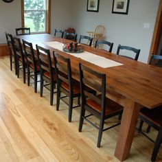 a large wooden table with chairs around it