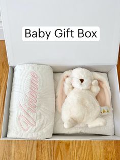 a baby gift box with a stuffed bunny and blanket