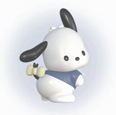 a white and black toy rabbit holding a yellow object in it's right hand