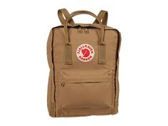 Fjallraven Kanken - Backpack Bags : Clay : Getting its start in 1978 among Swedish school children, the Fjällräven Kånken backpack has grown from a schoolyard staple to a fashion icon. The lightweight Kånken daypack is built on rugged Vinylon fabric, includes a comfortable foam back panel that doubles as a seat cushion, and has a simple-but-effective carry system that can be used as a tote or worn on the shoulders. Large main compartment to hold all your daily essentials. Front zip pocket for ad Fjallraven Kanken Backpack Acorn, Fjallraven Kanken Light Oak, Fjallraven Kanken Backpack Big, Fjallraven Kanken Laptop 15, Fjall Raven Kanken Backpack Pink, Fjällräven Kånken, Backpack Free, School Yard, School Children