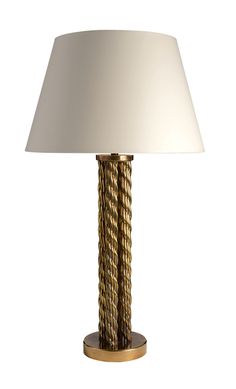 a table lamp with a white shade on it's base and gold trimmings