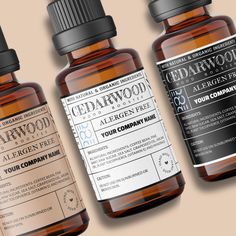 three bottles of cedarwood essential oil on a tan background with the label above them