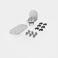 an assortment of screws and brackets on a white background