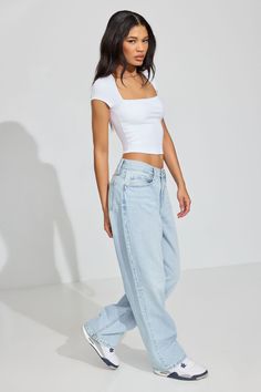 These baggy-fit jeans sit low on the hips and come with a bigger, full-length leg that bunches at the bottom. Perfect for your biggest sweater or your tiniest shirt. We're so in our bag rn. Features - Five-pocket styling - Zip-fly with button closure Size & Fit - Fit: Relaxed - Rise: 10.5" - Inseam: 33.5" - Model is wearing size 3 Materials & Care - Content: 75% cotton, 25% organic cotton - Care: Wash cold, inside out - Imported Tight Shirt Baggy Pants, Tight Shirt Loose Pants Outfit, Baggy Jeans Outfit 90s, Light Wash Baggy Jeans, Tiny Shirts, Garage Jeans, Loose Pants Outfit, Baggy Jeans Outfit, Low Rise Baggy Jeans