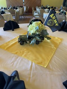 a bouquet of flowers on top of a table in a room with tables and chairs