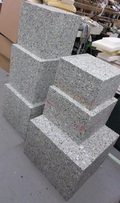 three stacks of granite sitting next to each other