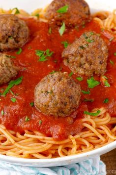 spaghetti with meatballs and parsley on top