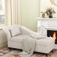 a living room with a white couch and fire place in the fireplace, next to a window