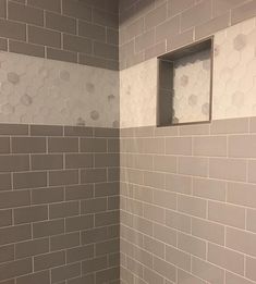 a white toilet sitting in a bathroom next to a shower head mounted on a wall