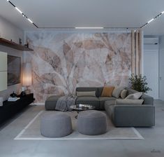 a living room with a couch, ottoman and coffee table in front of a large painting on the wall