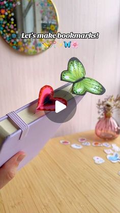 someone is holding up a box with butterflies on it and the video below shows how to make them look like they are flying