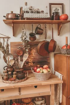 a wooden shelf filled with pots and pans next to other kitchen utensils