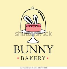 the logo for bunny bakery, with a cake in a glass dome on a yellow background