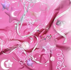 a pink background with stars, hearts, and other items on it's surface