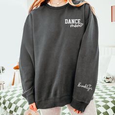 "Custom Dance Mom Sweatshirt with Dancer(s) Name on Sleeve, Trendy Dance Mom Crewneck, Dance Mom Personalized Comfort Colors Sweatshirt Gift How To Order - Please make sure you have looked at all sizes and color charts. - Select from the various T-shirt sizes and colors from scroll-down menus. - Fill in the personalization box (if provided) as exemplified. - Click \"Add to cart\" button. You can turn back and add more items of different size and color. Order Process - Our processing time is 5-10 Custom Crewneck Sweatshirts, Mom Crewneck, S Name, Comfort Colors Sweatshirt, Dance Mom, Mom Sweatshirt, Color Charts, Dance Moms, Comfort Colors