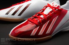 the adidas soccer shoes are red and white