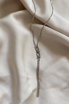 This delicate silver lariat necklace is the perfect addition to any elegant neckline. The perfect combination of shiny and blackened silver, delicacy, and kicking style, this necklace is sure to turn heads. Whether you are dressing up for a special occasion or just want to add a touch of luxury to your everyday look, this dainty silver lariat necklace is the perfect choice. Order your dainty silver lariat necklace today and add a touch of elegance to your wardrobe! Silver Dangle Chain Necklace Gift, Silver Adjustable Long Charm Necklace, Adjustable Silver Long Charm Necklace, Trendy Silver Metal Lariat Necklace, Trendy Silver Chain Lariat Necklace, Silver Adjustable Long Charm Necklaces, Adjustable Long Silver Charm Necklace, Elegant Silver Snake Chain Charm Necklace, Metal Long Necklace With Silver Chain For Gifts