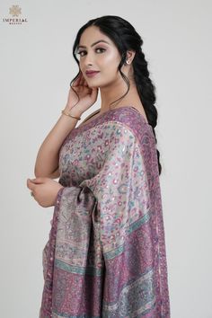 The Dusty Rose Pink Kani Silk Saree is crafted from luxurious silk fabric and features intricate Kani weaving throughout. This saree showcases traditional motifs such as paisleys and florals in a soft, dusty rose pink hues, enhanced by delicate zari thread work that adds a touch of regality. It is elegantly paired with a contrasting Kani blouse piece adorned with complementary booti patterns, completing the ensemble with refined grace.   The design of this Pashmina Silk saree is deeply inspired by the beauty and heritage weaves of the ancient Pashmina shawls, a tradition that dates back to the grandeur of the Mughal era. Kani, an ancient art form rooted in the Kashmir Valley, has a history that stretches back to 3000 BC and has been lovingly preserved and passed down through generations. W Luxury Zari Work Pashmina Shawl, Luxury Pashmina Shawl With Zari Work, Pashmina Silk, Traditional Silk Saree, Pink Crafts, Silk Gifts, Dusty Rose Pink, Traditional Motifs, Festive Wear