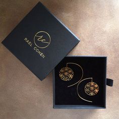 a pair of earrings in a black box