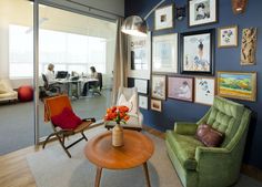 a living room filled with furniture and pictures on the wall