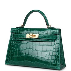 This tiny Kelly, in the Sellier style, is in Emerald shiny Mississippiensis alligator with gold hardware and has tonal stitching, two front straps with front toggle closure, single rolled handle and removable shoulder strap.The interior is lined with Emerald leather and has one open pocket on the back wall.Collection: ZOrigin: FranceCondition: New (plastic on hardware)Accompanied by: Hermès box, Hermès dustbag, shoulder strap, shoulder strap dustbag, felt, carebook, CITES Measurements:﻿ 7.5" width x 4.5" height x 2.2" depth; 2.5" handle drop, 18.5" Shoulder Strap dropDelivery 5-8 or 10-15 working days Please note that during high season and Sale period, delivery times may be affected We accept payment with a Credit card, Debit card, or PayPal.Note: Our Items are totally New High quality Br Hermes Kelly Sellier, Kelly Sellier, Jewelry Gift Guide, Hermes Box, School Bags For Kids, Hermes Bags, Carry All Bag, Baby Bag, Handbag Backpack