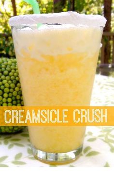 a close up of a drink in a glass with the words creamsice crush on it