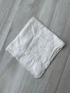 This listing is for one vintage, handkerchief. It is all white with intricate floral eyelet detail. There is one set of flowers on each corner. The sunflower shaped has the eyelet details and the other flowers are embroidered. It has scalloped edging for added interest. This cotton handkerchief is in good vintage condition. There are NO holes and NO tears. There is a tiny stain. Previously owned and used. Please see pictures for further details. Would make a beautiful table centerpiece or someth White Wedding Handkerchiefs For Summer, Vintage Embroidered Summer Handkerchiefs, White Flower-shaped Handkerchiefs As Gift, White Embroidered Flower-shaped Handkerchiefs, White Embroidered Flower Shaped Handkerchiefs, Summer White Handkerchiefs Gift, Vintage Wedding Handkerchiefs For Summer, Vintage White Handkerchiefs For Spring, Vintage White Handkerchief For Gifts