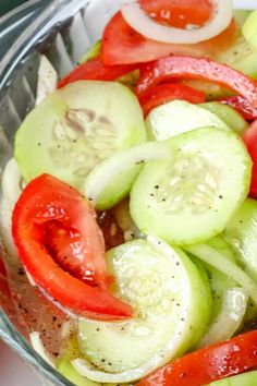 cucumber, tomato and onion salad in a glass bowl